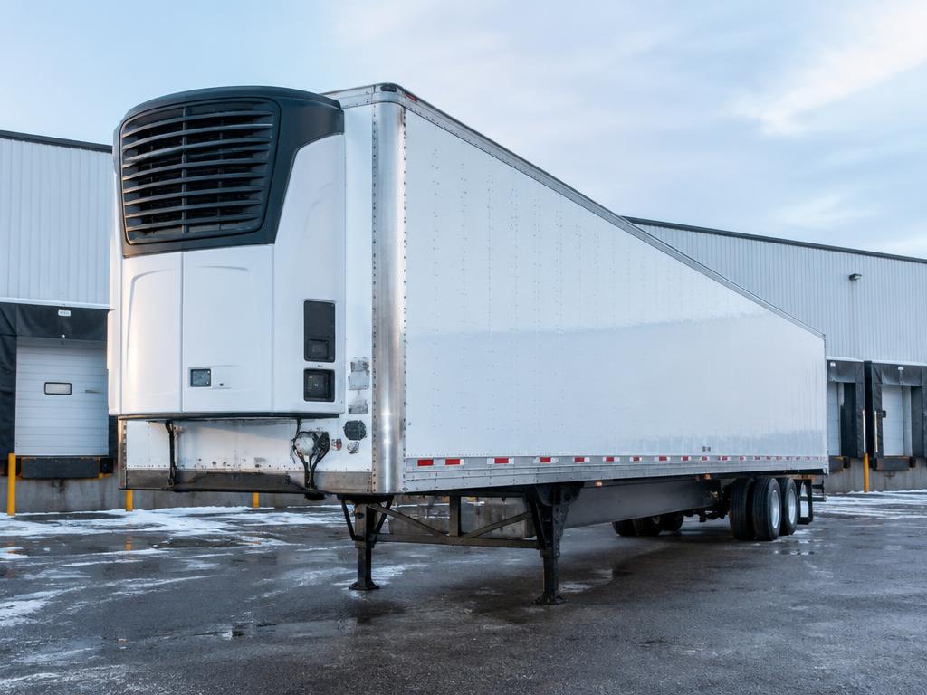 Refrigerated reefer trailer with refrigeration unit parked at a cold storage warehouse